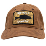 A brown cotton baseball cap featuring a rectangular embroidered patch on the front with a black fish silhouette and the words 'xpress boats' in white over a yellow topographic pattern.