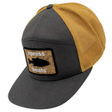 A 5-panel trucker cap with a dark gray front panel and brim, a mustard yellow mesh back, and a rectangular front patch featuring a fish silhouette and the text 'xpress boats'.