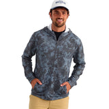 A man wearing a blue digital camo printed hoodie with a half-zip front and a grey xpress logo on the right chest.