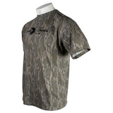 Side of a brown tree camo t-shirt with a black xpress logo on the chest.