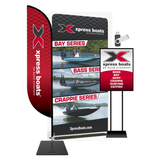 Promotional display for Xpress Boats showing various boat models on a pop up banner, a sign, a flag, and a USB drive.