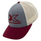 A tri-tone trucker hat with a heather gray front panel, cream mesh back panels, and a burgundy brim. The front panel features a large embroidered burgundy 'X' logo.